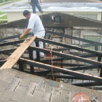 Damaged roof with exposed trusses
