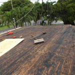 Flat roof stripped down to bare wood planks