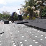 New weather-proofing material being applied to roof