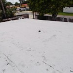 After photo of flat roof with white cap-sheet