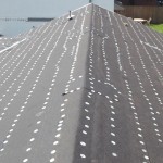 Roofing paper installed with tin cap