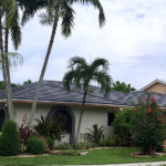 After photo of a home with new charcoal flat roof tiles installed